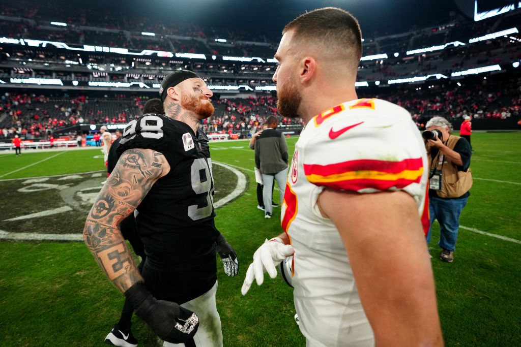 Maxx Crosby #98 of the Las Vegas Raiders and Travis Kelce #87 of the Kansas City Chiefs meet on the...