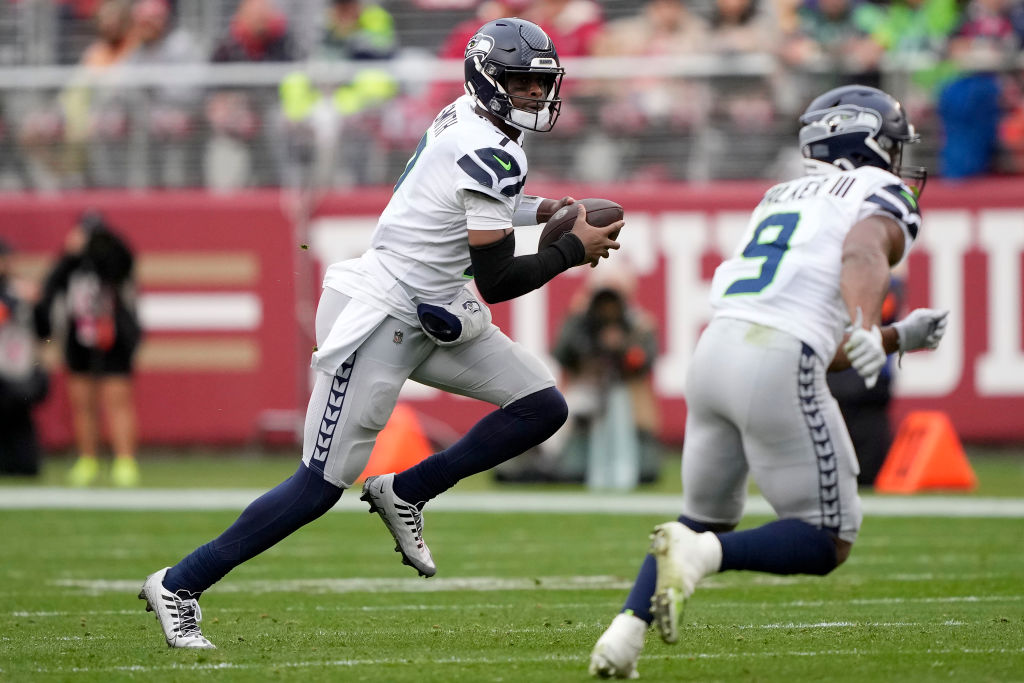 Geno Smith #7 of the Seattle Seahawks runs the ball with Kenneth Walker III #9 against the San Fran...