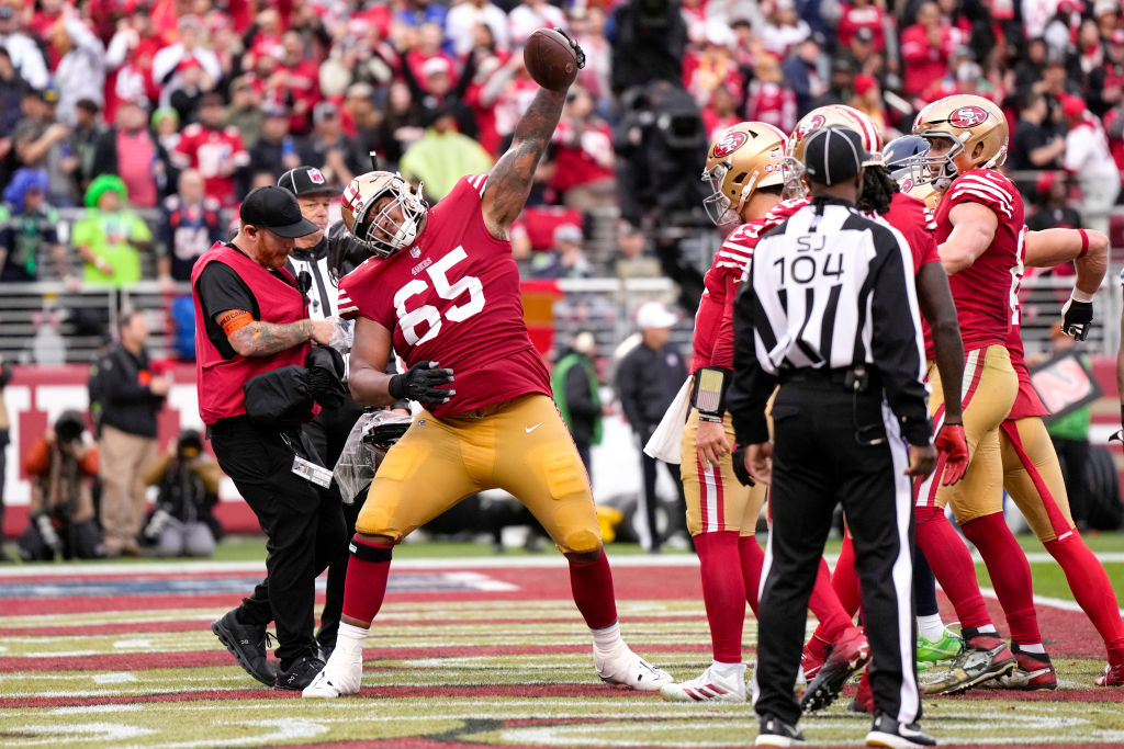 Aaron Banks #65 of the San Francisco 49ers celebrates after a touchdown is scored by Brock Purdy #1...