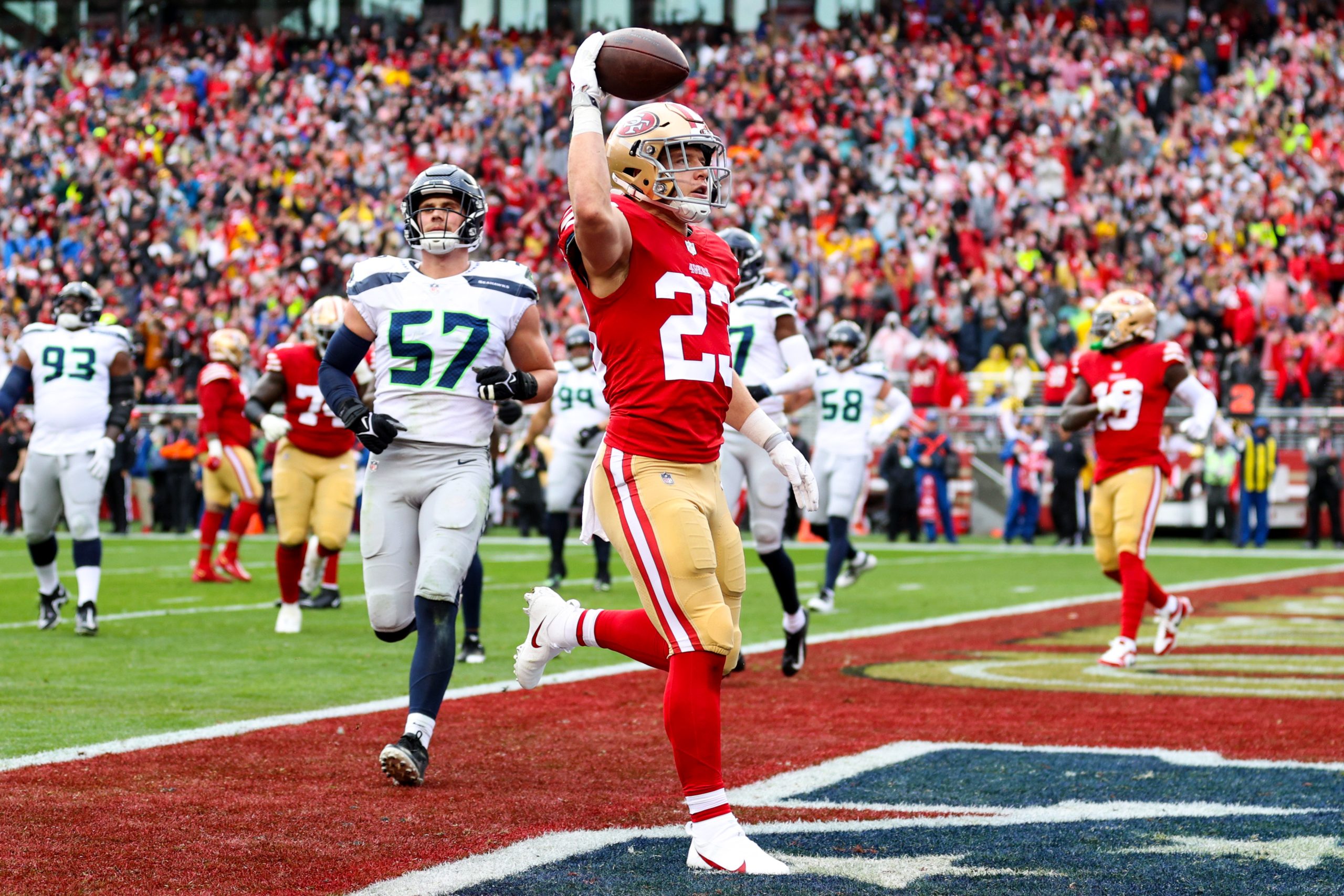 Christian McCaffrey #23 of the San Francisco 49ers celebrates after scoring a 3 yard touchdown agai...