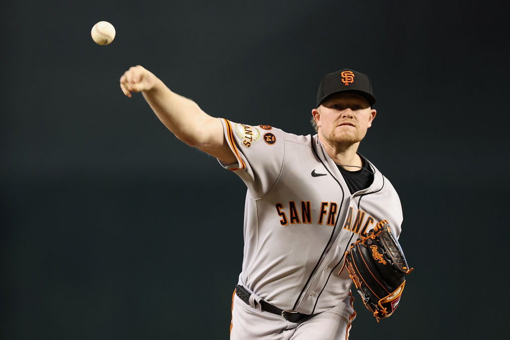 Stating pitcher Logan Webb #62 of the San Francisco Giants throws a warm-up pitch during the first ...
