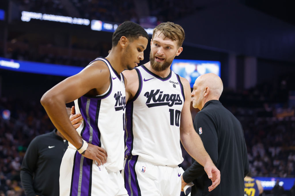 Domantas Sabonis #10 of the Sacramento Kings talks to teammate Keegan Murray #13 during a timeout i...