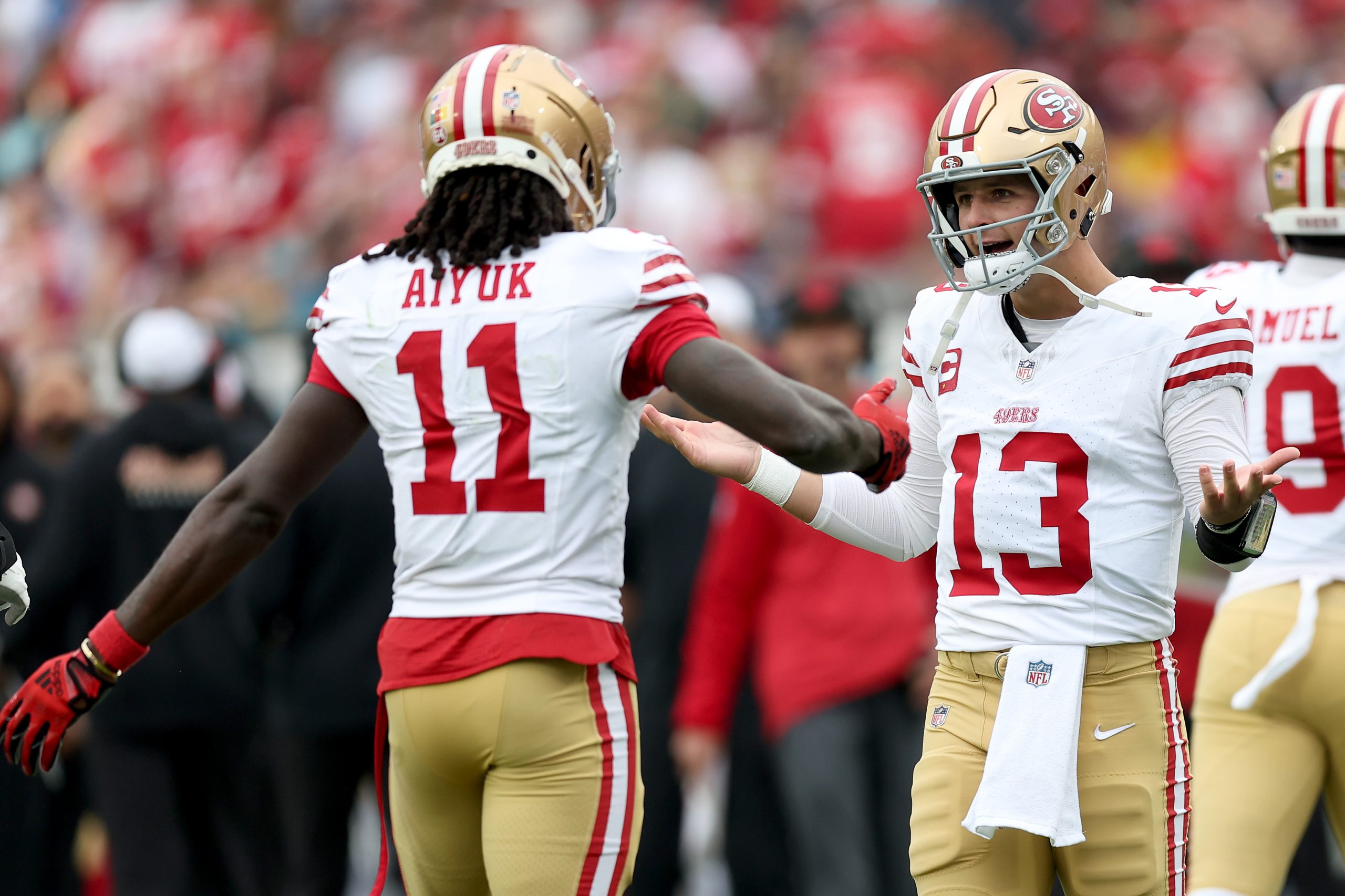 Brock Purdy #13 of the San Francisco 49ers celebrates a touchdown with Brandon Aiyuk #11 of the San...