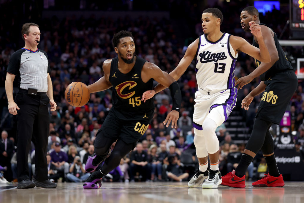 Donovan Mitchell #45 of the Cleveland Cavaliers is guarded by Keegan Murray #13 of the Sacramento K...