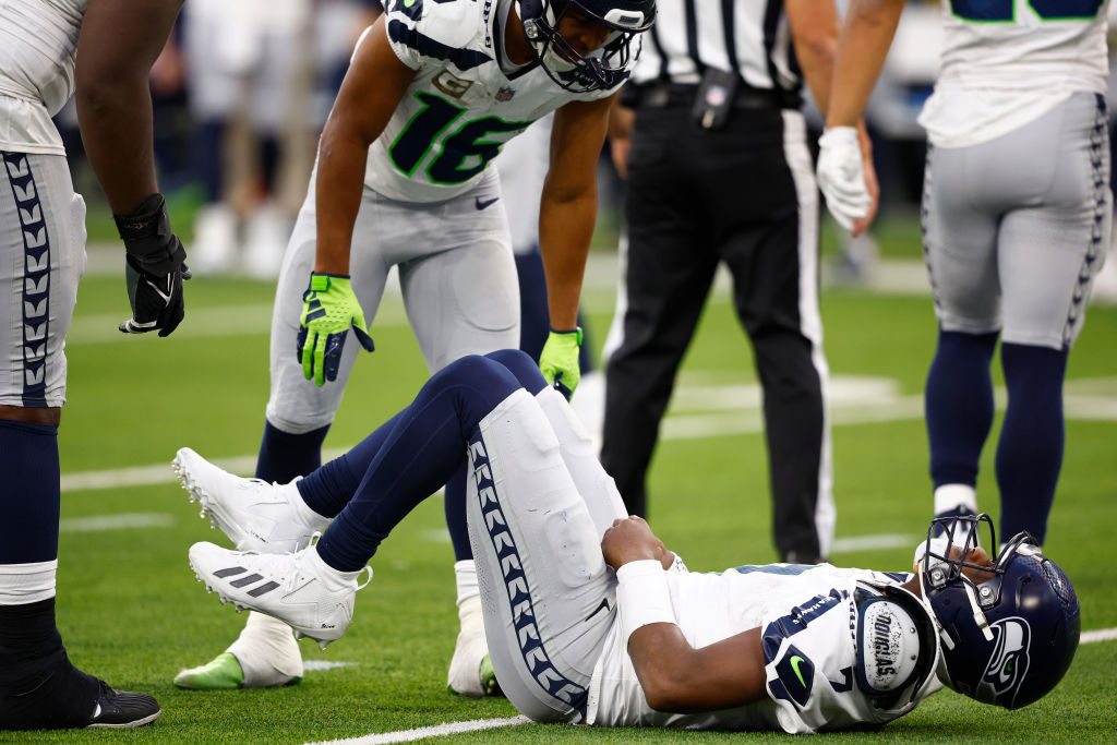 Geno Smith #7 of the Seattle Seahawks on the field with an injury during the third quarter in the g...