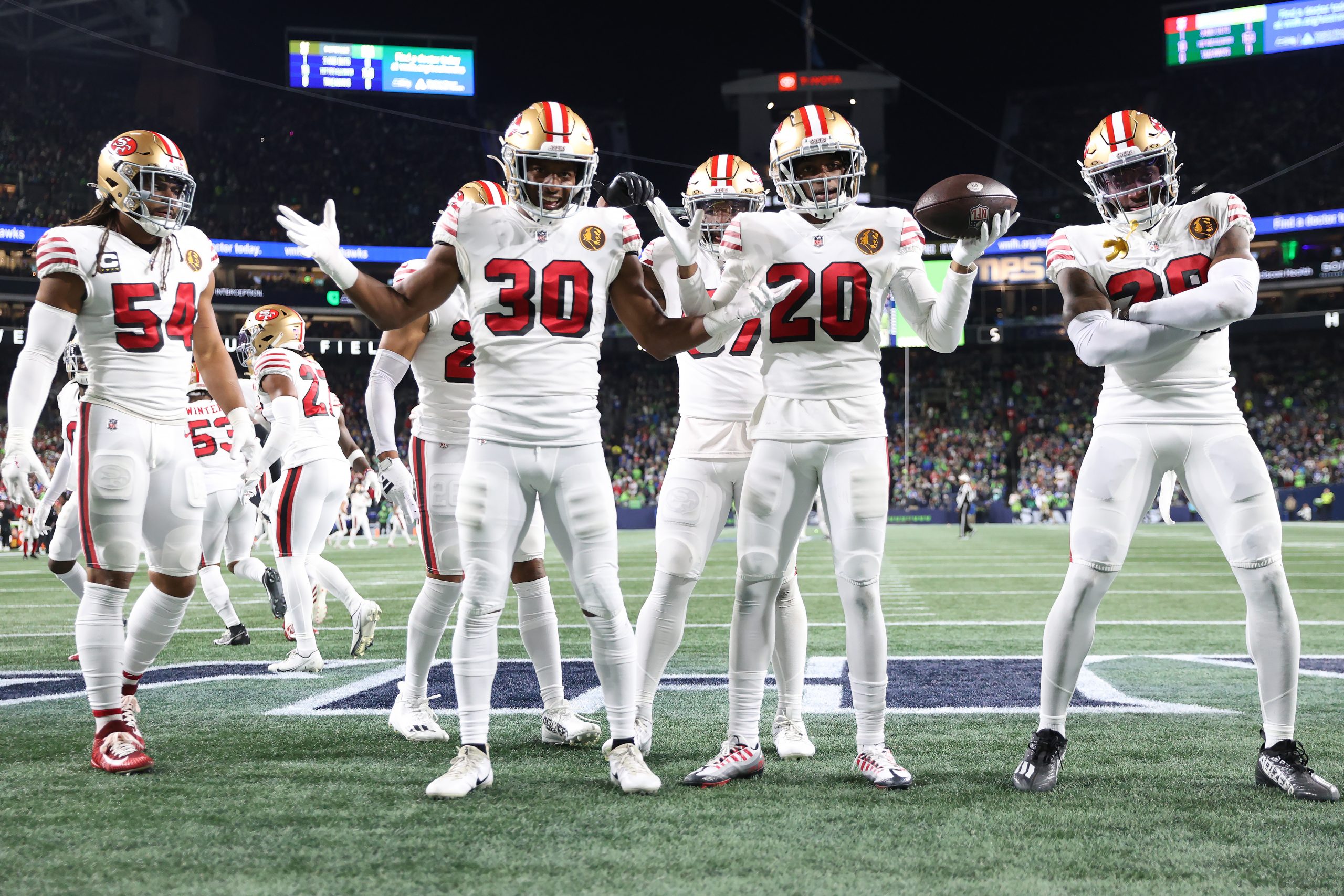 Ambry Thomas #20 of the San Francisco 49ers celebrates an interception with teammates during the se...