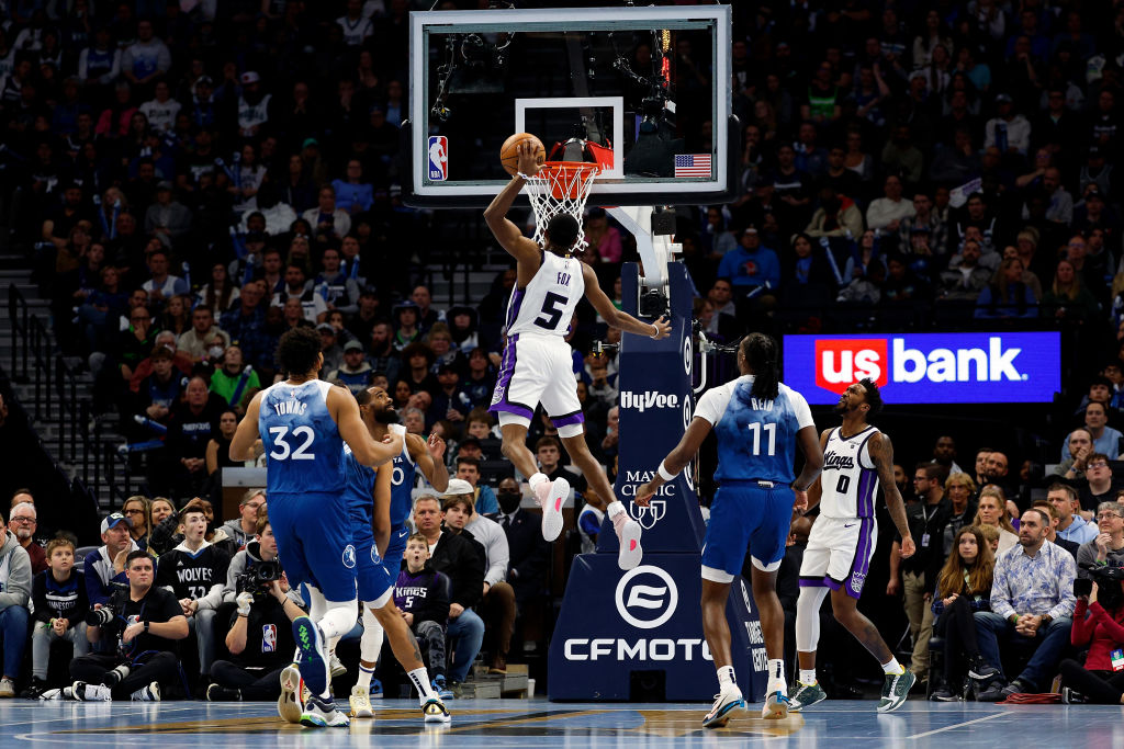 MINNEAPOLIS, MINNESOTA - NOVEMBER 24: De'Aaron Fox #5 of the Sacramento Kings dunks the ball agains...