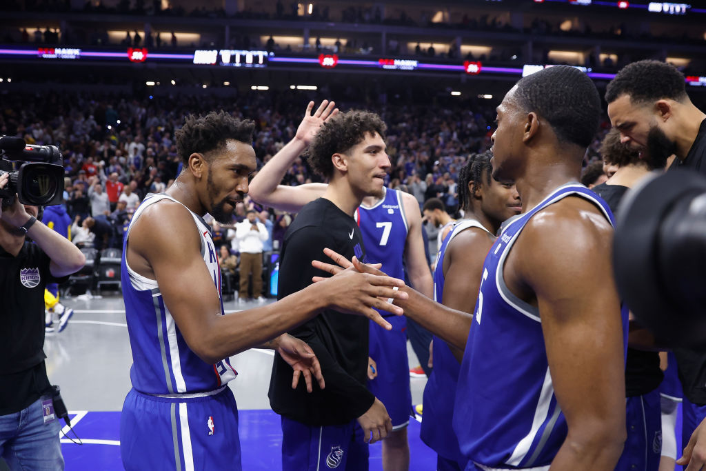 Malik Monk #0 of the Sacramento Kings celebrates with De'Aaron Fox #5 after a win W during the NBA ...