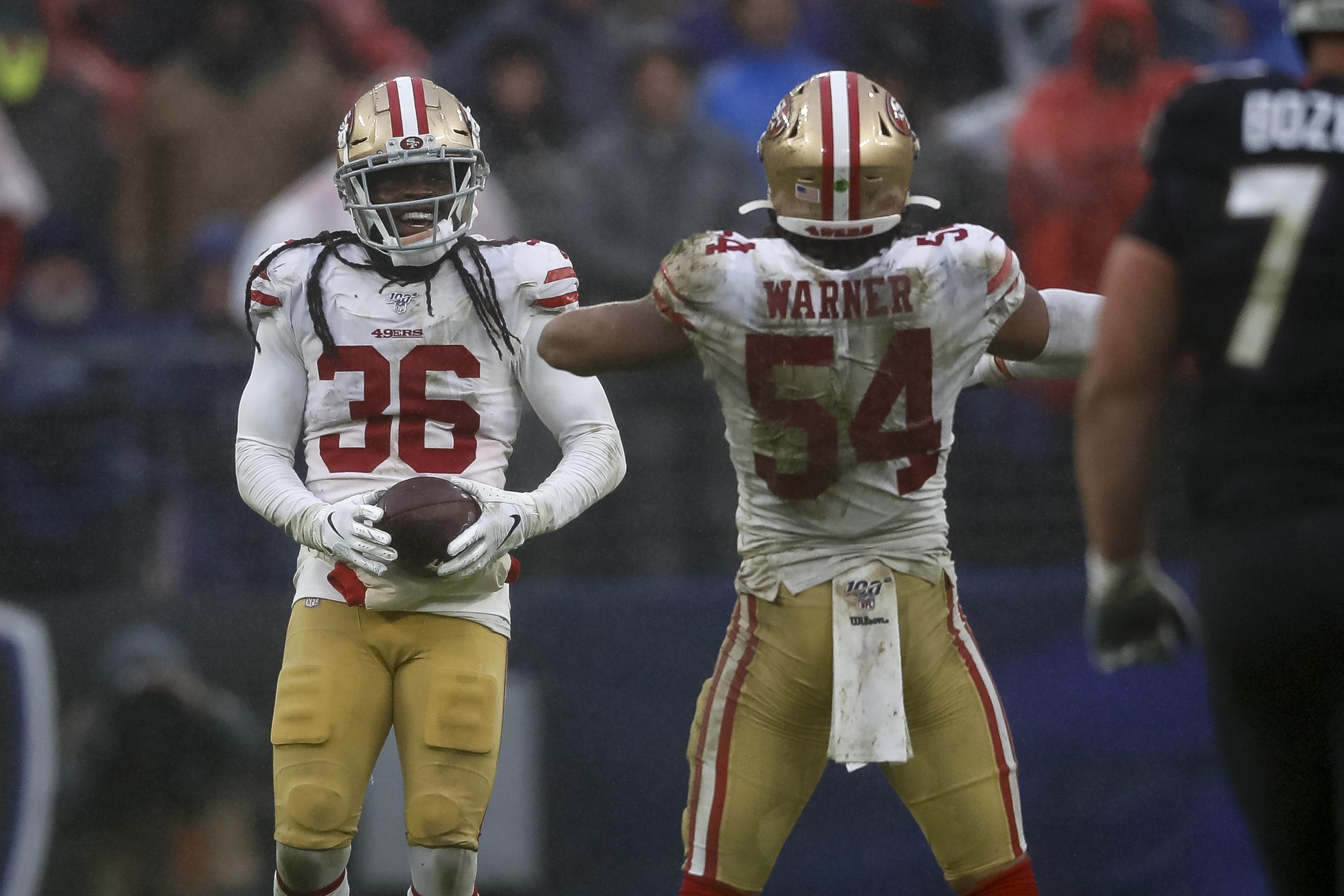 Marcell Harris #36 of the San Francisco 49ers celebrates with Fred Warner #54 after a play against ...