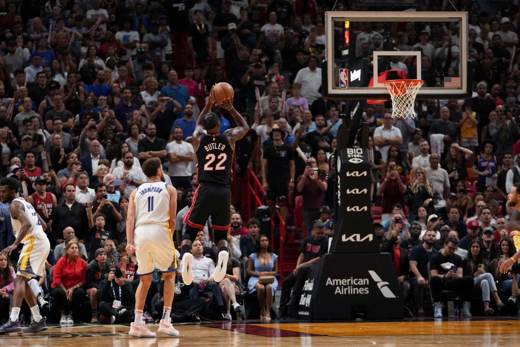 Jimmy Butler #22 of the Miami Heat shoots a jump shot past Klay Thompson #11 of the Golden State Wa...
