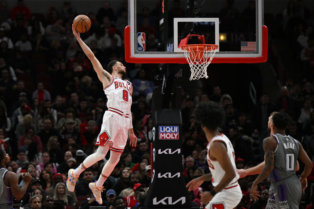 CHICAGO, ILLINOIS - MARCH 15: Zach LaVine #8 of the Chicago Bulls attempts a dunk in the second hal...
