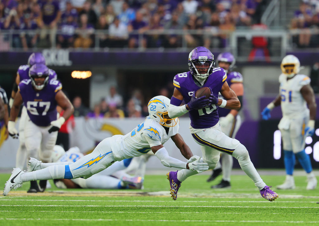 Justin Jefferson #18 of the Minnesota Vikings runs past JT Woods #22 of the Los Angeles Chargers wh...