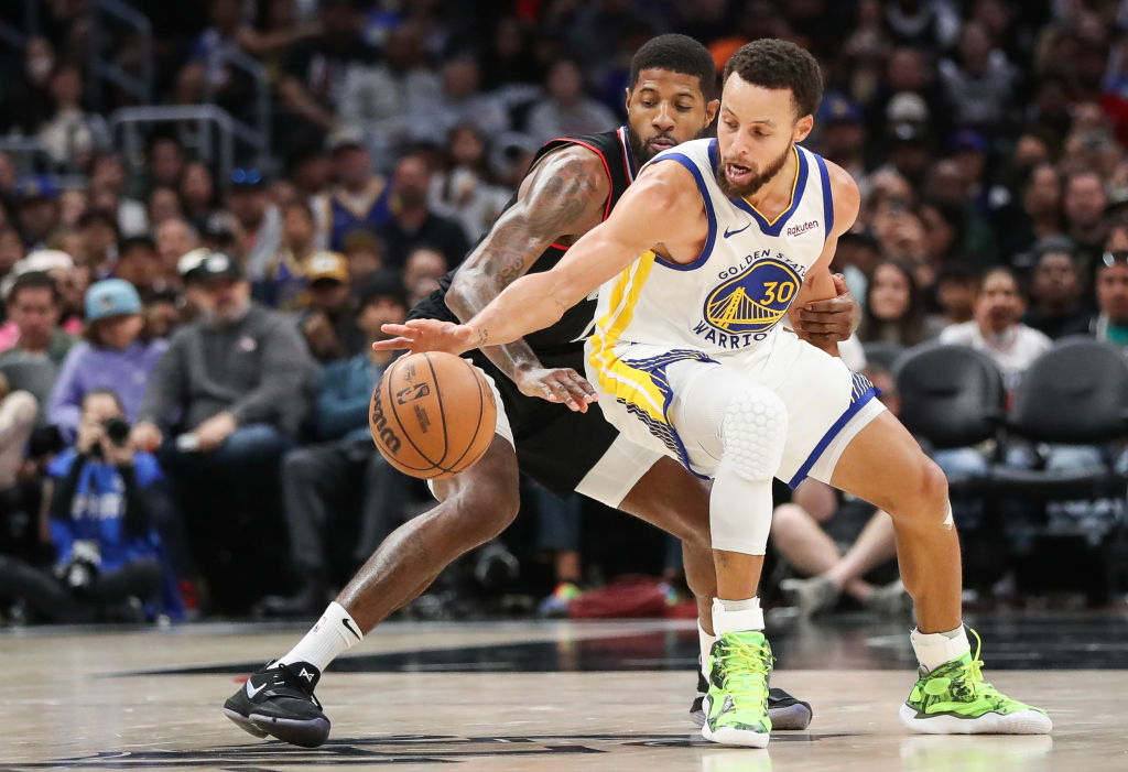 Stephen Curry #30 of the Golden State Warriors handles the ball defended by Paul George #13 of the ...