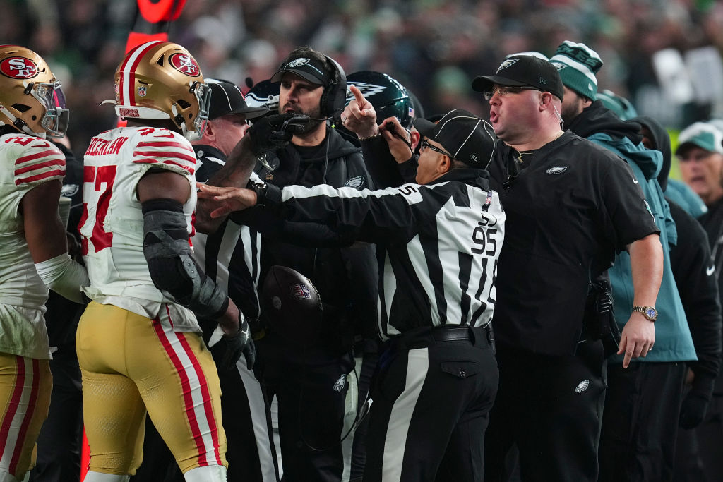 Dre Greenlaw #57 of the San Francisco 49ers gets into an altercation with head of security Dom DiSa...