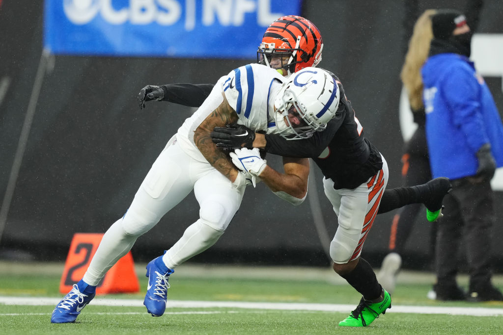 Michael Pittman Jr. #11 of the Indianapolis Colts is tackled by DJ Turner II #20 of the Cincinnati ...