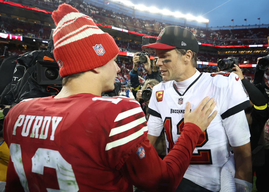 Brock Purdy #13 of the San Francisco 49ers talks with Tom Brady #12 of the Tampa Bay Buccaneers fol...