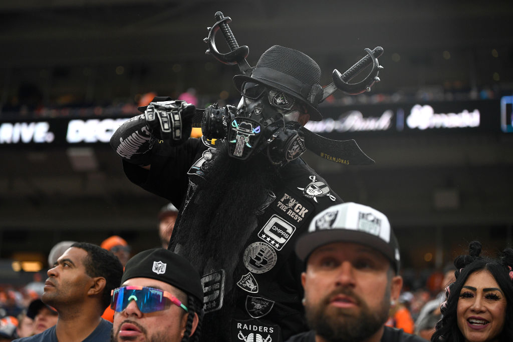 A Las Vegas Raiders fan poses for a picture during his team's game against the Denver Broncos at Em...