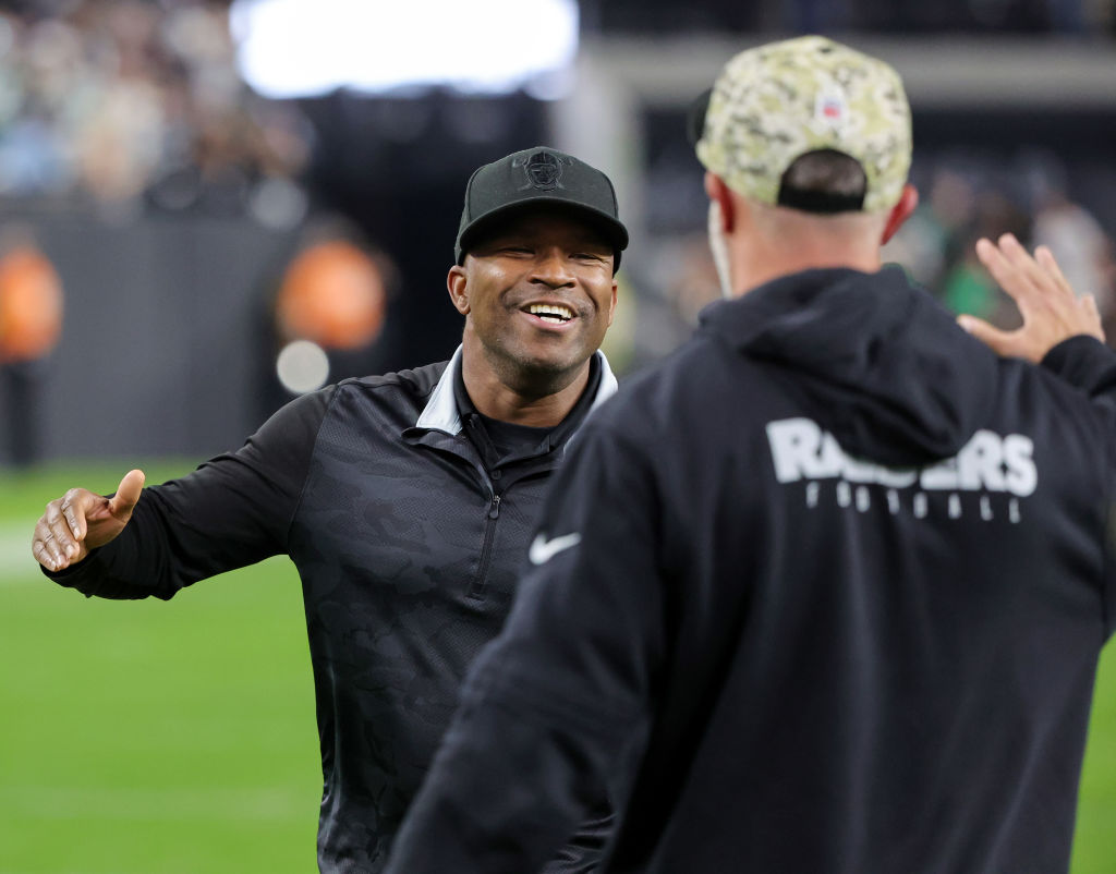 Interim general manager Champ Kelly (L) of the Las Vegas Raiders celebrates on the field after the ...