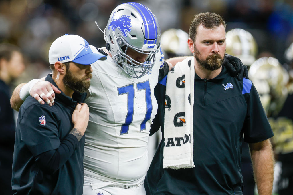 Frank Ragnow #77 of the Detroit Lions is helped off the field after being injured in the first quar...