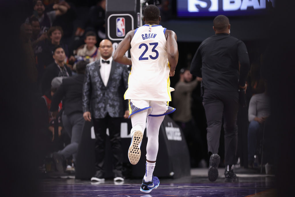 Draymond Green #23 of the Golden State Warriors runs off the court after being ejected for a flagra...