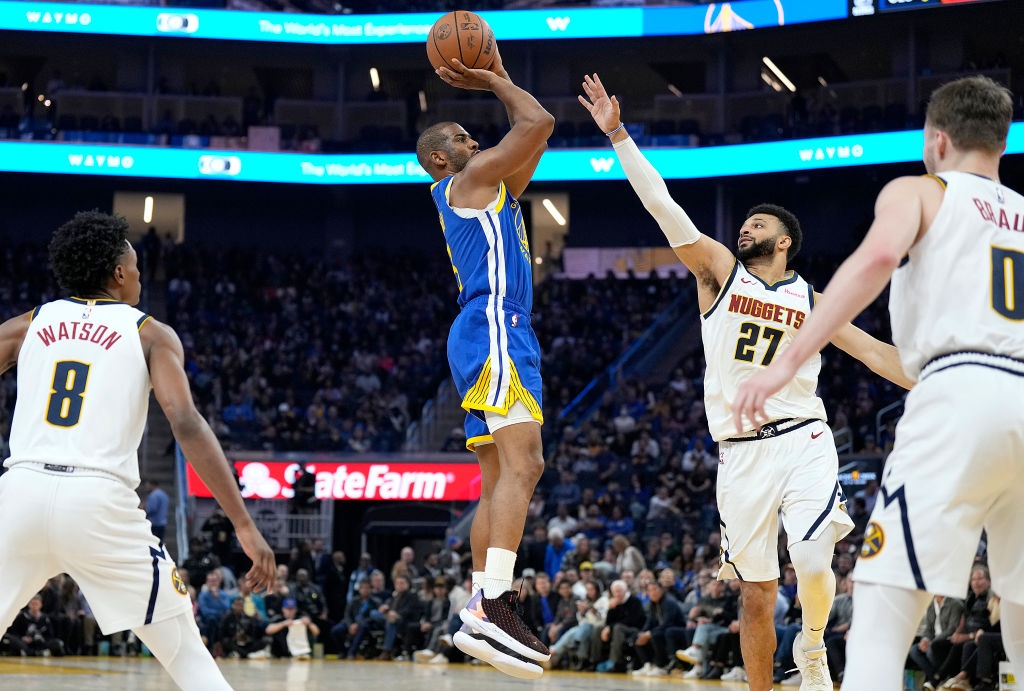 Chris Paul #3 of the Golden State Warriors shoots the ball against Jamal Murray #27 of the Denver N...
