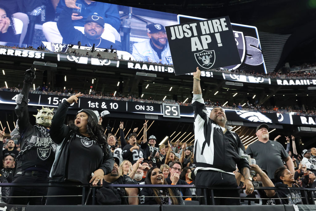 A Las Vegas Raiders fan holds up a sign saying the team should hire Antonio Pierce during the fourt...