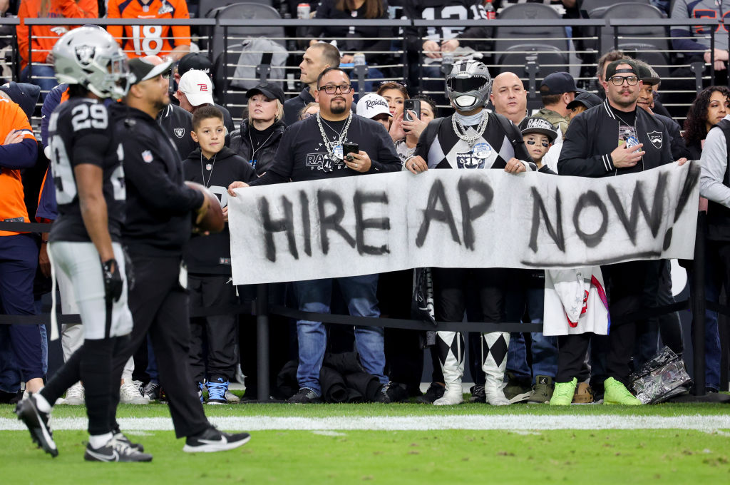 Las Vegas Raiders fans hold up a sign supporting interim head coach Antonio Pierce, using his nickn...