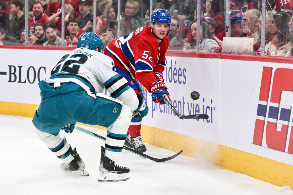 Justin Barron #52 of the Montreal Canadiens plays the puck along the boards during the first period...