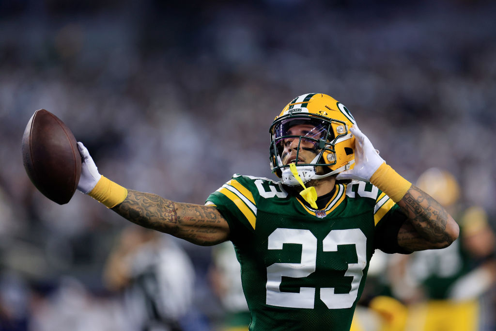 Jaire Alexander #23 of the Green Bay Packers reacts to an interception during the first quarter aga...