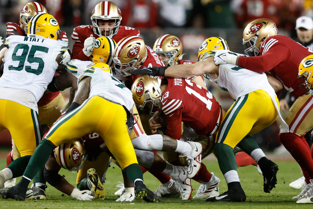 Brock Purdy #13 of the San Francisco 49ers sneaks for a first down during the fourth quarter agains...