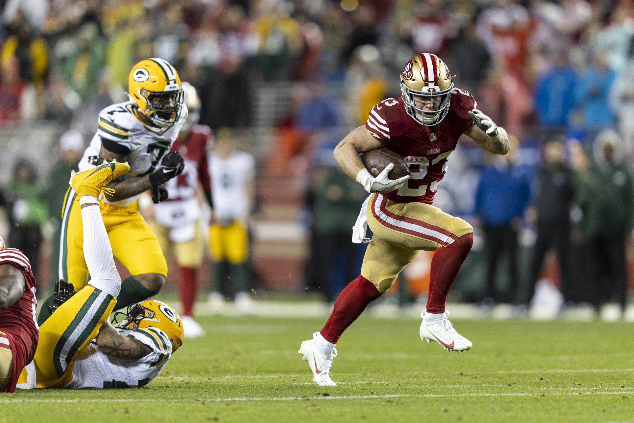Christian McCaffrey #23 of the San Francisco 49ers runs with the ball for a touchdown during an NFL...