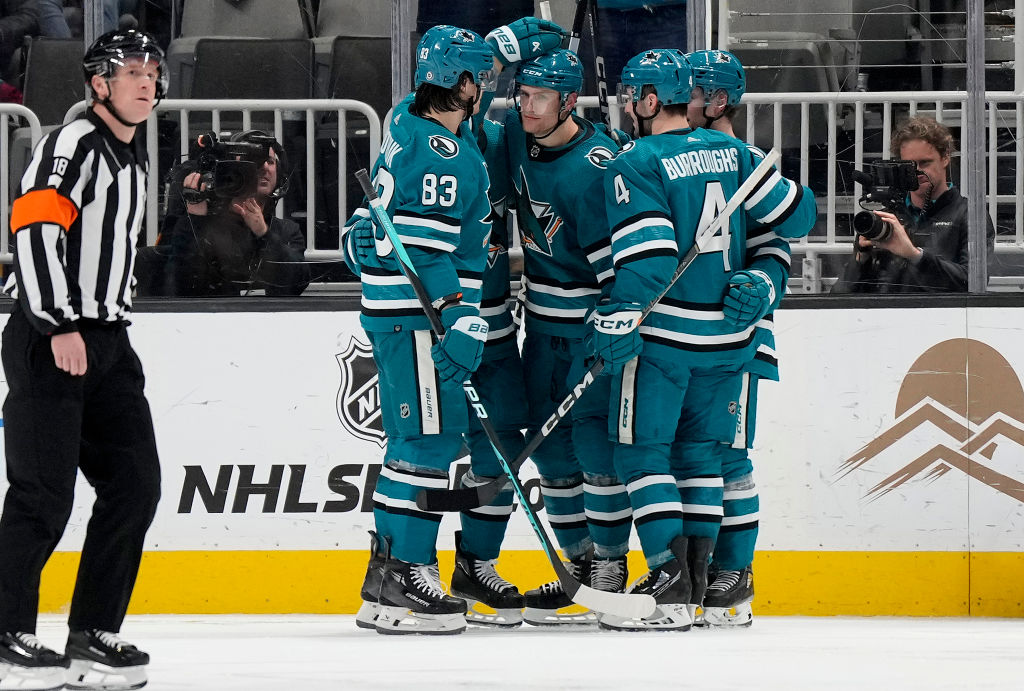 Nico Sturm #7 of the San Jose Sharks is congratulated by teammates after he scored a goal against t...