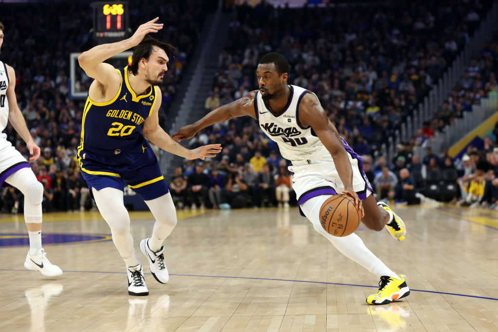 Harrison Barnes #40 of the Sacramento Kings is guarded by Dario Saric #20 of the Golden State Warri...