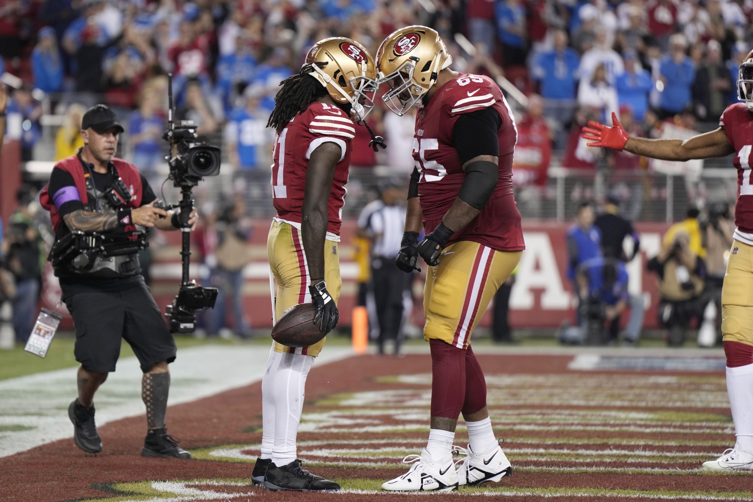 Brandon Aiyuk #11 of the San Francisco 49ers celebrates with Aaron Banks #65 after scoring a touchd...