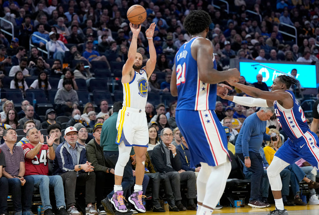 Stephen Curry #30 of the Golden State Warriors shoots a three-point shot against the Philadelphia 7...