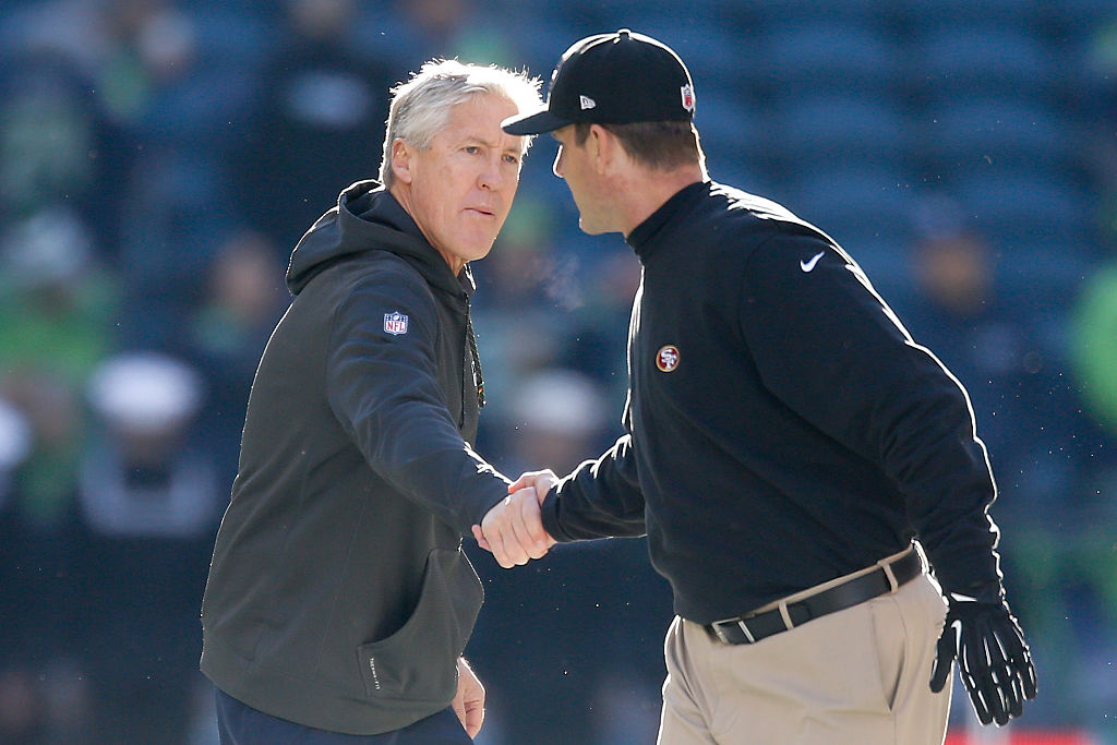 Head coach Pete Carroll (L) of the Seattle Seahawks shakes hands with head coach Jim Harbaugh (R) o...