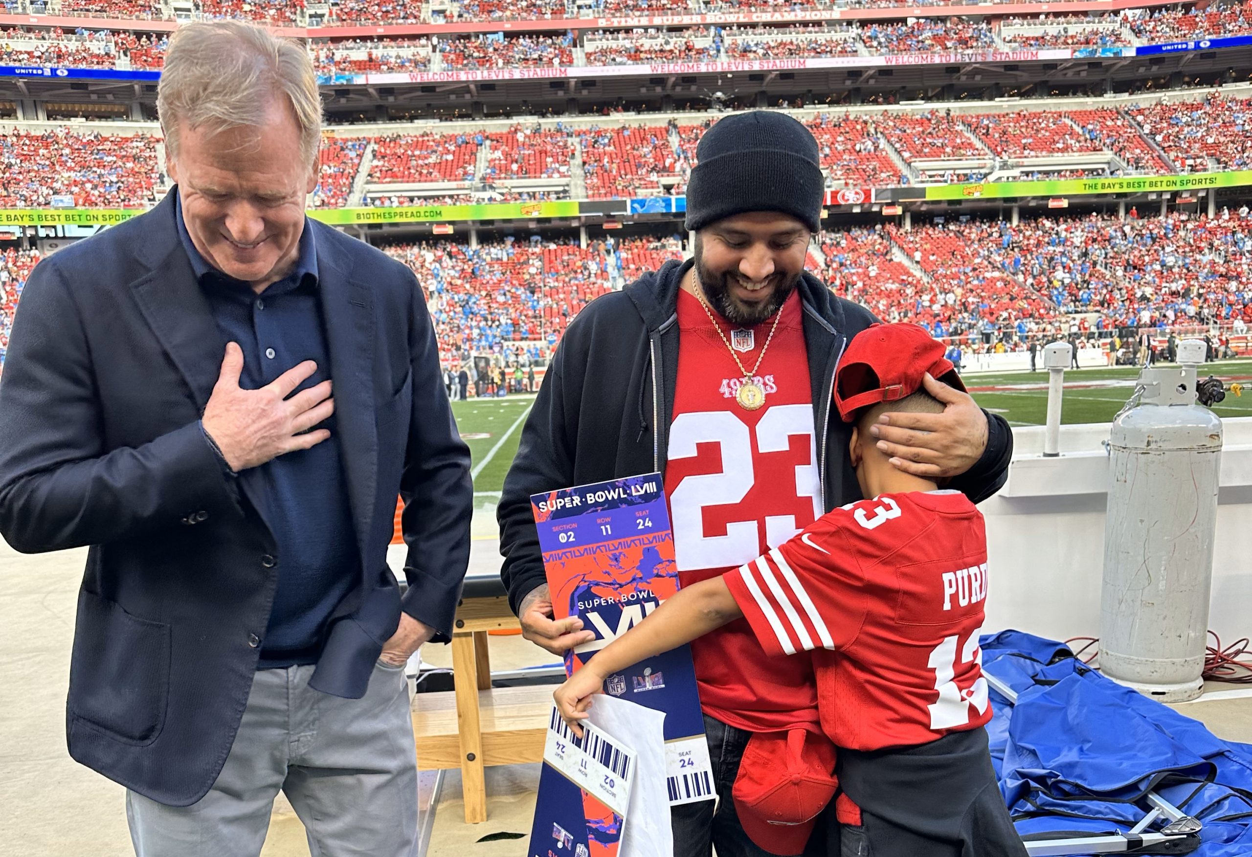 NFL Commissioner Roger Goodell presents two tickets to Super Bowl LVIII to 10-year-old Adrian McInt...
