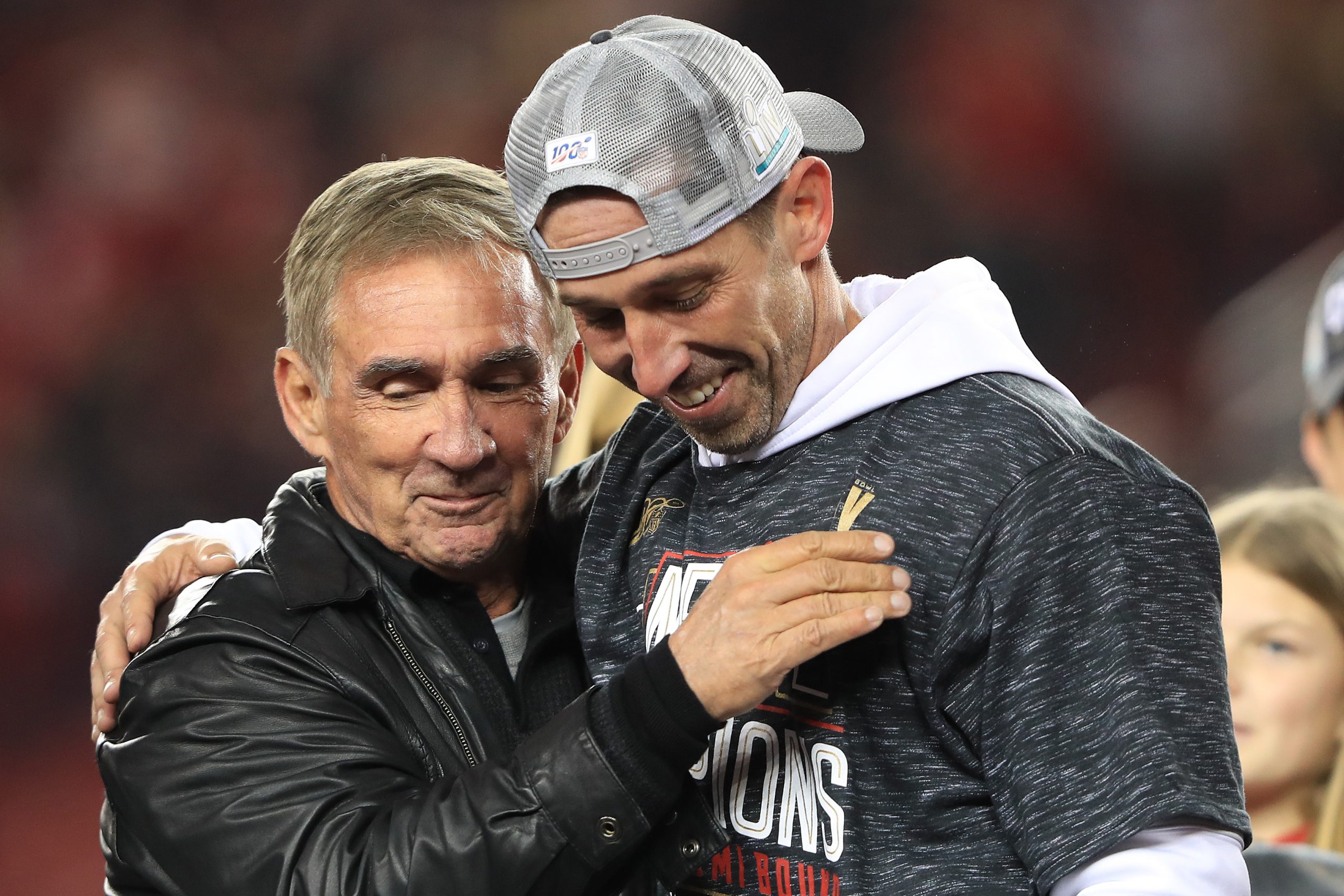 Head coach Kyle Shanahan of the San Francisco 49ers celebrates with his father, Mike Shanahan, afte...