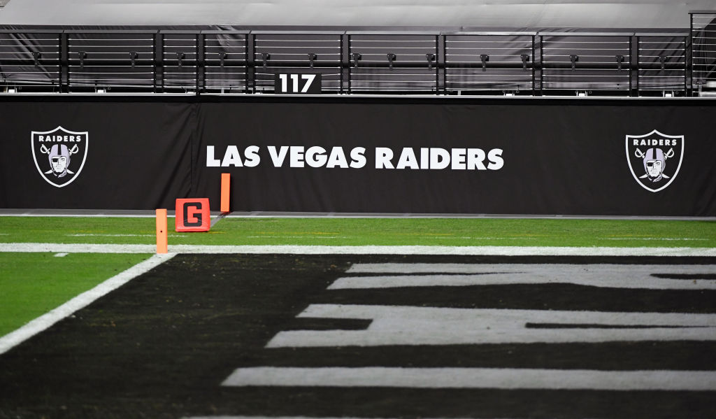 Las Vegas Raiders logos are shown on a wall before a game between the Raiders and the Los Angeles C...