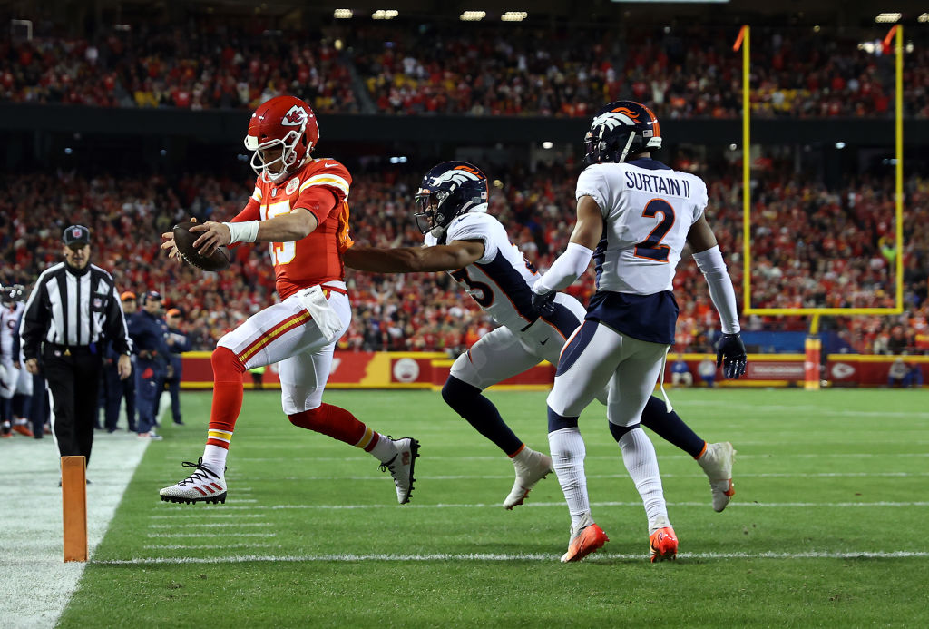 Patrick Mahomes #15 of the Kansas City Chiefs crosses the goal line for a touchdown as Kyle Fuller ...