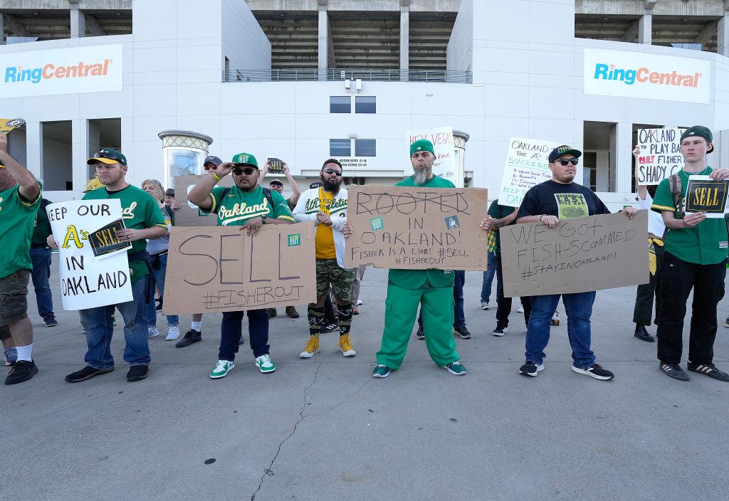 With the decision to move from Oakland to Las Vegas fans of the Oakland Athletics protest with sign...