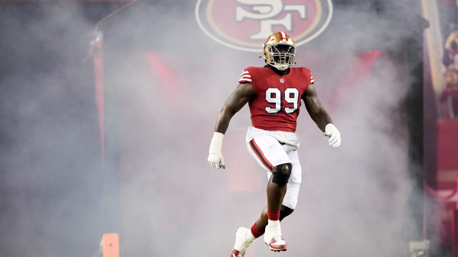 Javon Kinlaw #99 of the San Francisco 49ers jumps while running onto the field prior to a game against the Baltimore Ravens at Levi's Stadium on December 25, 2023 in Santa Clara, California.