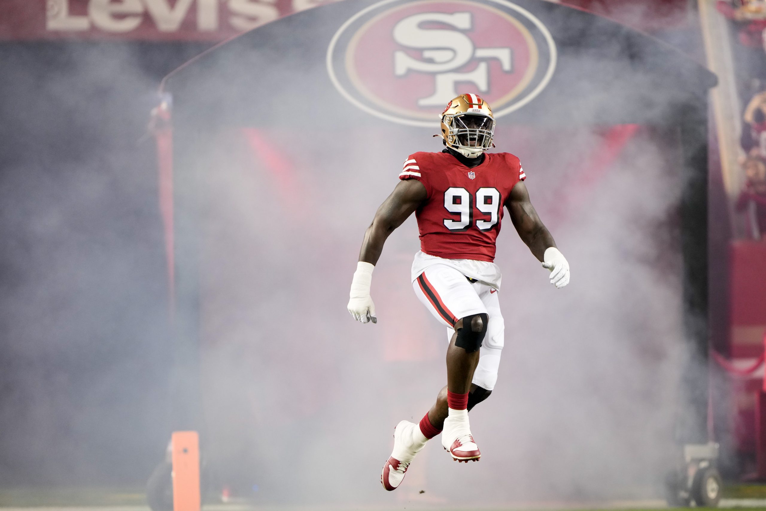 Javon Kinlaw #99 of the San Francisco 49ers jumps while running onto the field prior to a game agai...