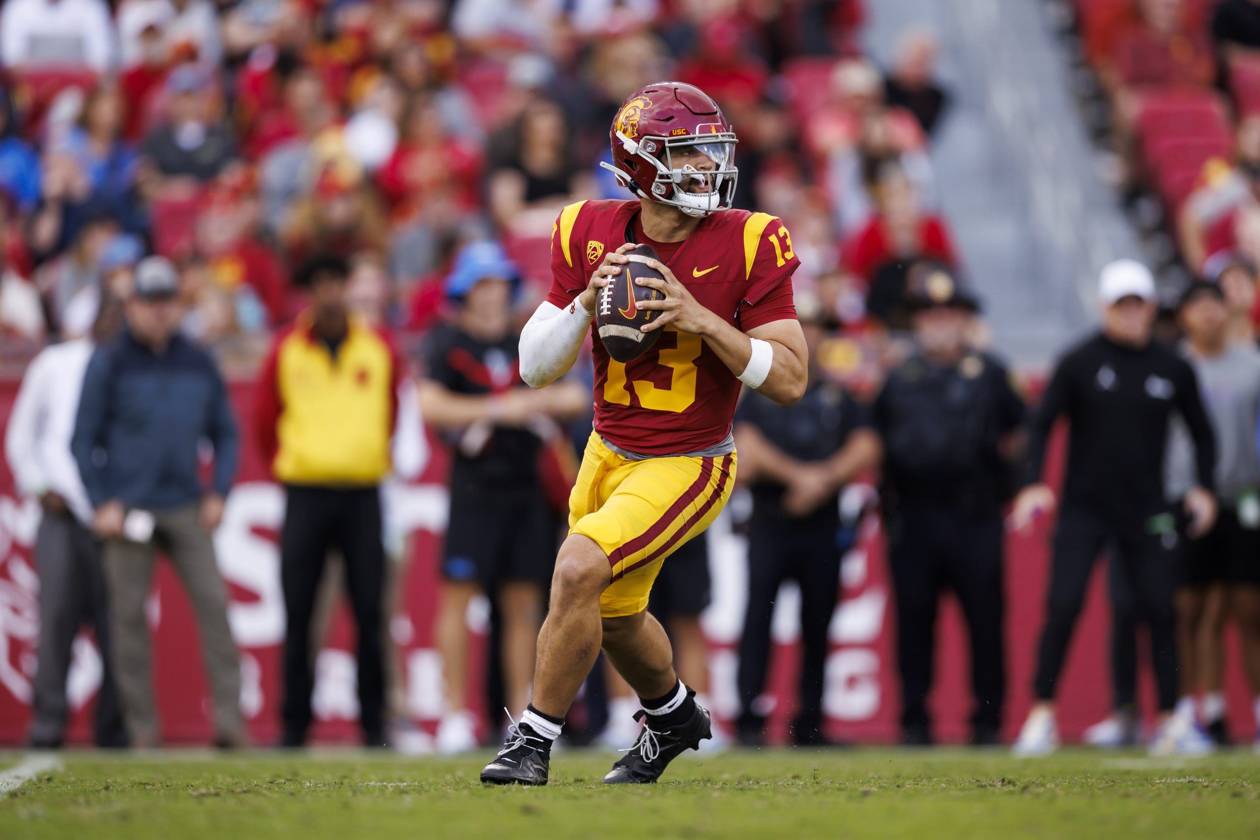 Caleb Williams #13 of the USC Trojans drops back and looks to throw a pass during the first half of...