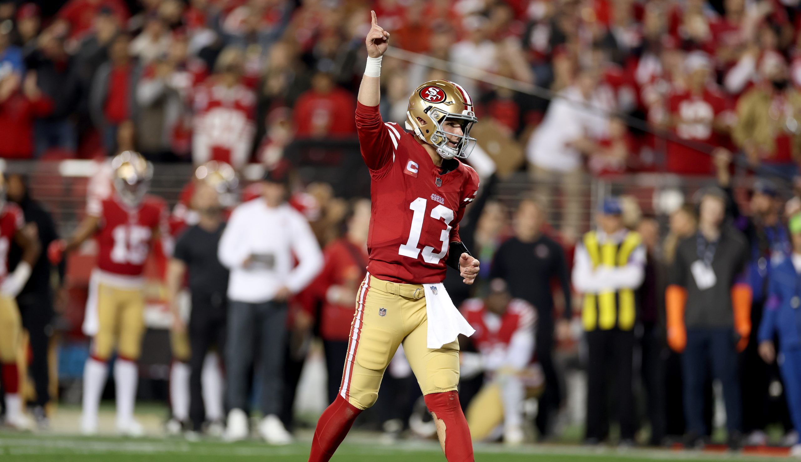 Brock Purdy #13 of the San Francisco 49ers reacts after the 49ers scored a touchdown against the De...