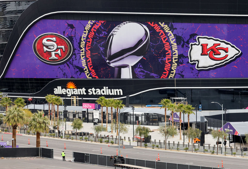 An exterior view shows an image of the Lombardi Trophy, team logos and signage for Super Bowl LVIII...
