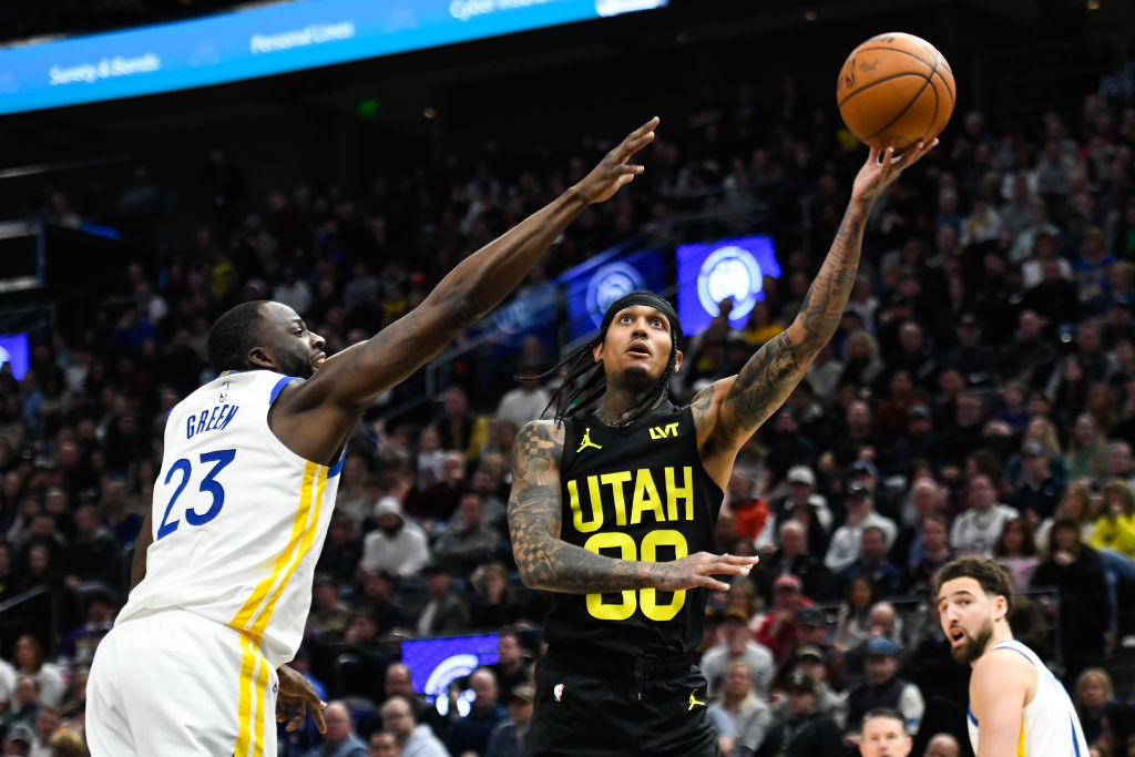 Jordan Clarkson #00 of the Utah Jazz puts up a shot against Draymond Green #23 of the Golden State ...
