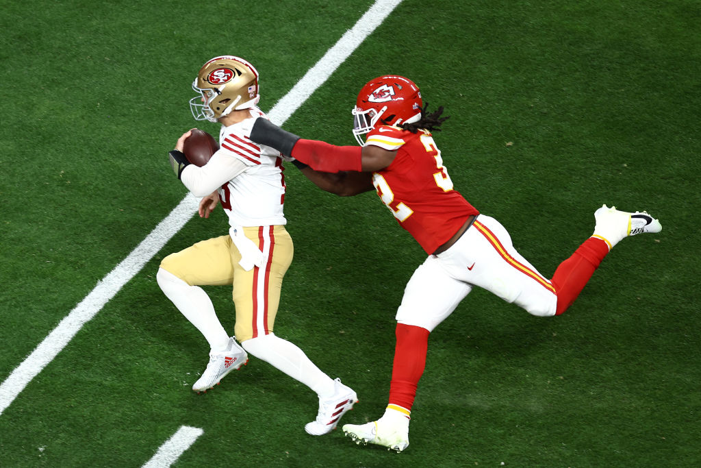 Nick Bolton #32 of the Kansas City Chiefs tries to tackle Brock Purdy #13 of the San Francisco 49er...