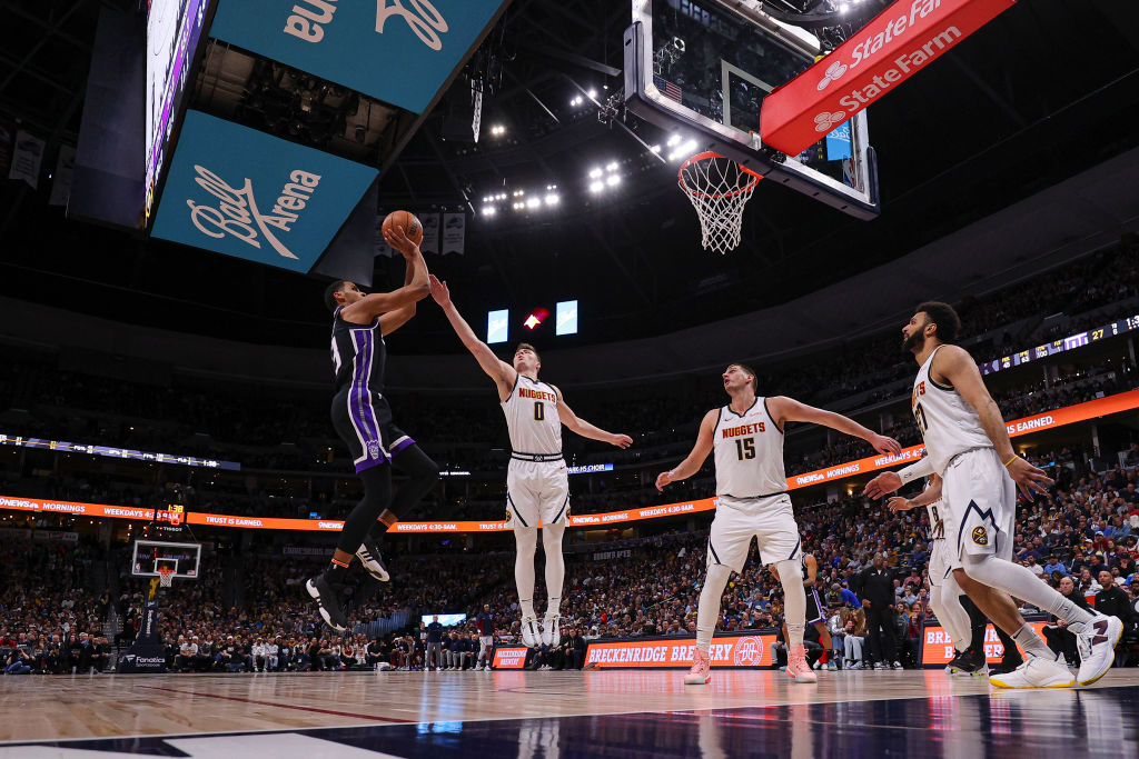 DENVER, COLORADO - FEBRUARY 28: Keegan Murray #13 of the Sacramento Kings shoots the ball during th...