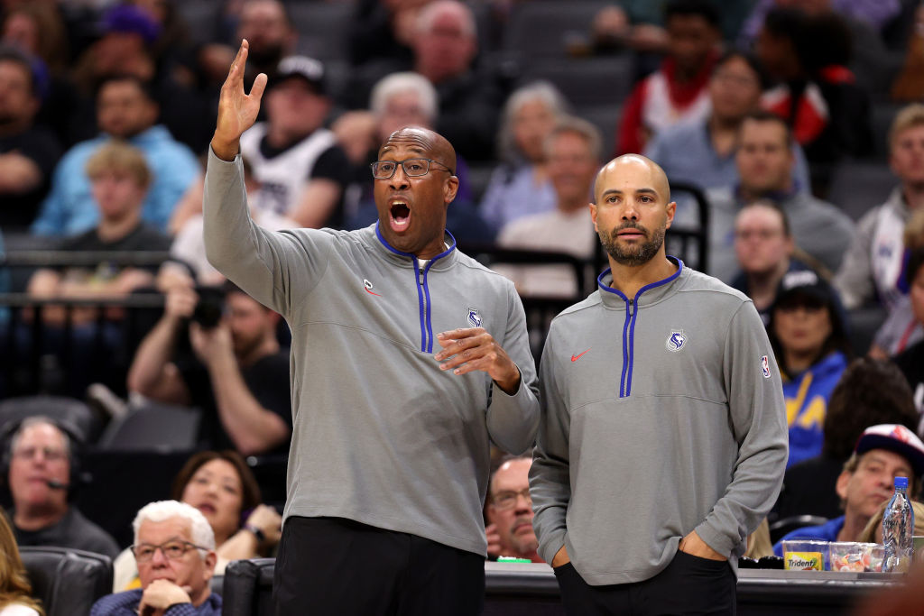 Sacramento Kings head coach Mike Brown (left) and assistant coach Jordi Fernandez watch their team ...